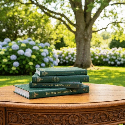 Stack of gardening books and guides on a wooden table, with PNW plants in the background